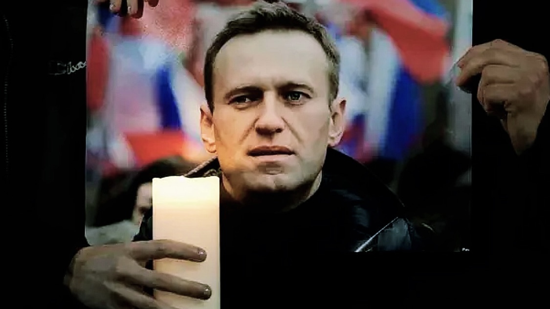 Protesters hold a picture of Alexei Navalny as they stage a demonstration opposite the Russian Embassy in London, Friday, Feb. 16, 2024, in reaction to the news that jailed Russian opposition leader Alexei Navalny has died in a Russian prison, according to the Federal Penitentiary Service. (AP Photo/Kin Cheung)