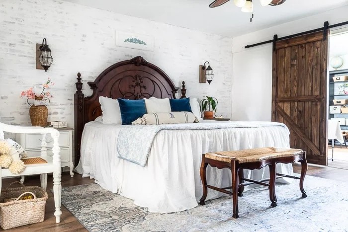 faux brick wall, cozy bed, barn doors, farmhouse floors