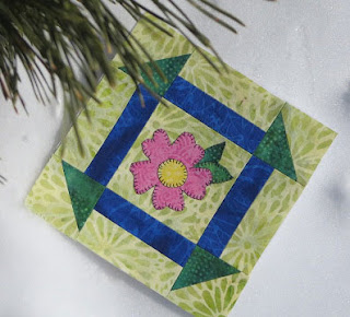 pink flower on a green quilt block