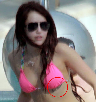 just below her bikini bra line I hope it's a fake tattoo