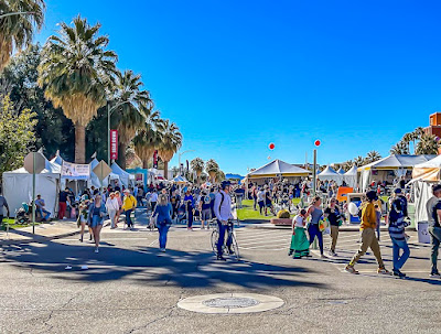 Photograph showing view of University of Arizona Mall with booths and crowd of people at the Tucson Festival of Books