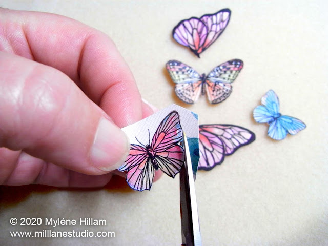 Cutting the butterflies out with fine scissors
