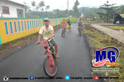 Bersepeda, Anak-anak Nikmati Jalan Aspal Mulus Program TMMD Jember