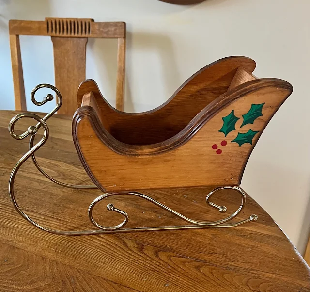 Photo of a thrifted Christmas sleigh decoration.