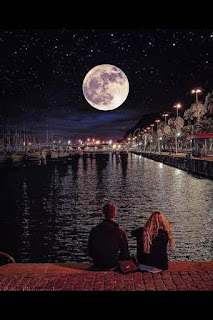 Man and woman (lovers) sitting together by a riverside at night; watching the full moon.