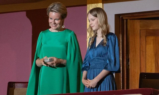 Princess Eleonore wore a riannette flared midi dress by Maje Paris. Queen Mathilde wore a green cape dress by Natan. Hayoung Choi