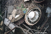 Found automotive art. A set of 1932 era Ford Model A V8 wire wheels lie in . (picton copy)