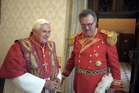 Pope Benedict XVI speaks with the new Grand Master of the Knights of Malta, Matthew Festing of Britain, during their meeting at the Vatican
