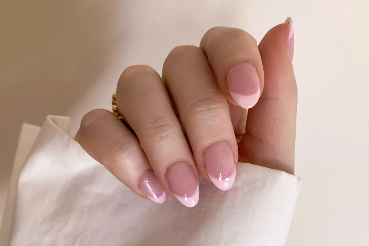 close-up of a ebautifully manicured woman's hand with a french tip design