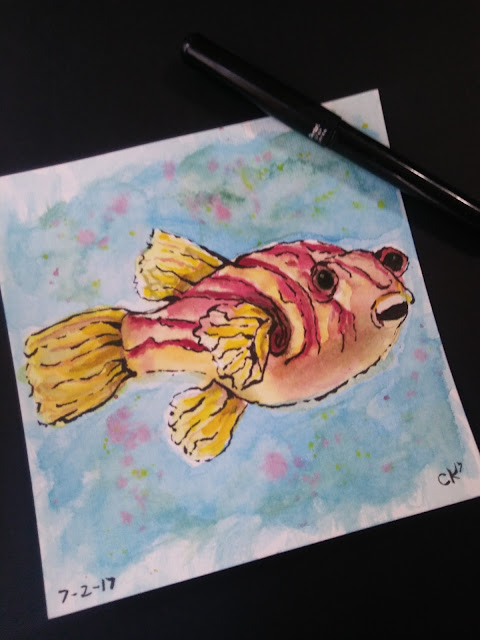 a watercolor painting of a yellow and red striped fish that appears to be smiling