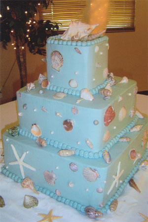 Stunning round four tier light blue wedding cake shaped to look as though 