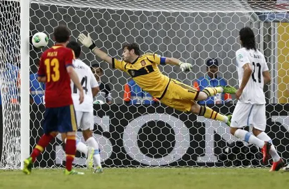 Spain goalkeeper Iker Casillas fails to save on a free-kick goal by Uruguay player Luis Suárez