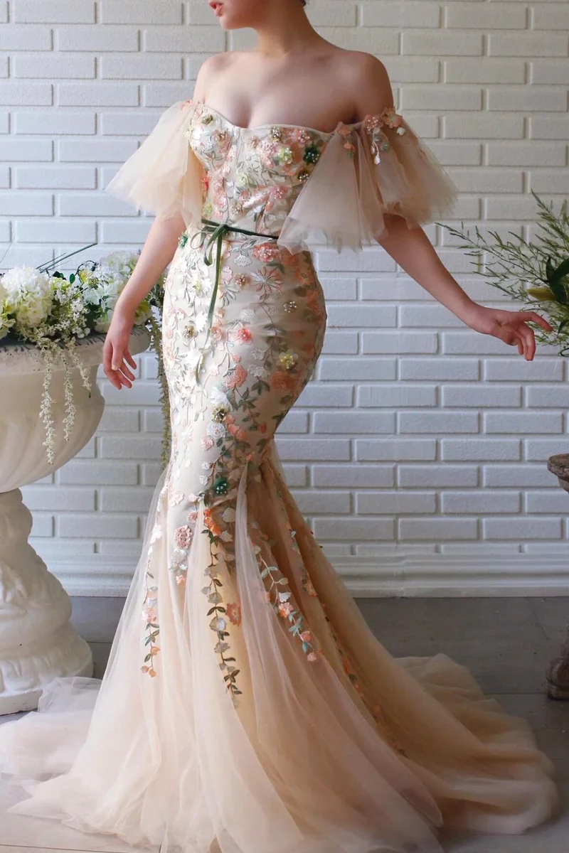 beautiful young woman in a fairy-like prom dress is posing on the street