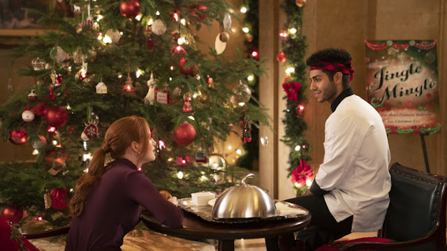 Madelaine Petsch and Mena Massoud star in "Hotel for the Holidays." Credit/ Shane Mahood | Amazon Freevee