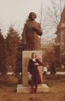 Sandra in front of  a statue in the park