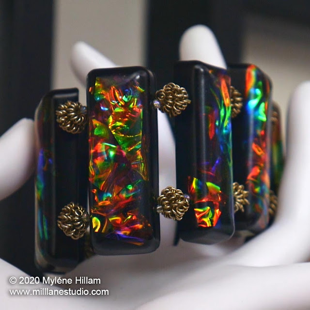 Faux opal resin bracelet made up of several log shaped pieces with silver wire coil beads in between