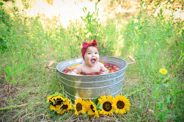 little girl in fruit bath