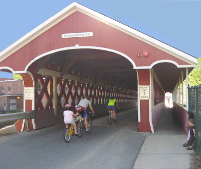 Cyclists riding through the Thompson Covered Bridge