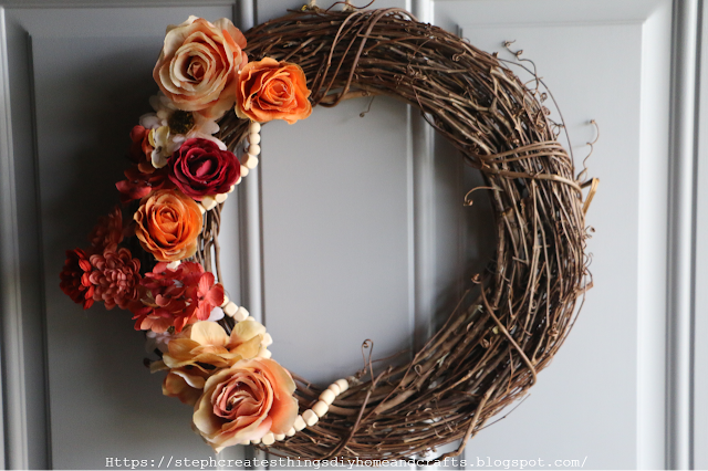 Grapevine wreath with beaded garland and faux flowers