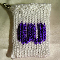 the letter W rendered in knitting