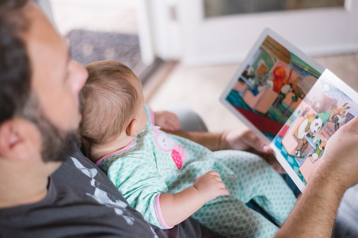 dad reading a picture book with child for fathers day