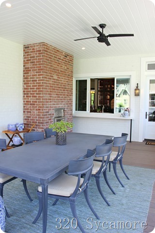 outdoor eating area with pizza oven and sliding window