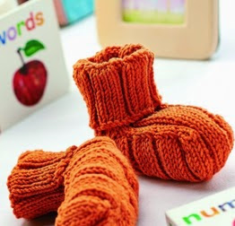 http://www.letsknit.co.uk/free-knitting-patterns/halloween-baby-hat-and-bootees