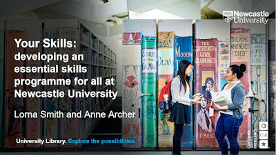 Two students standing next to books shelves at Newcastle University