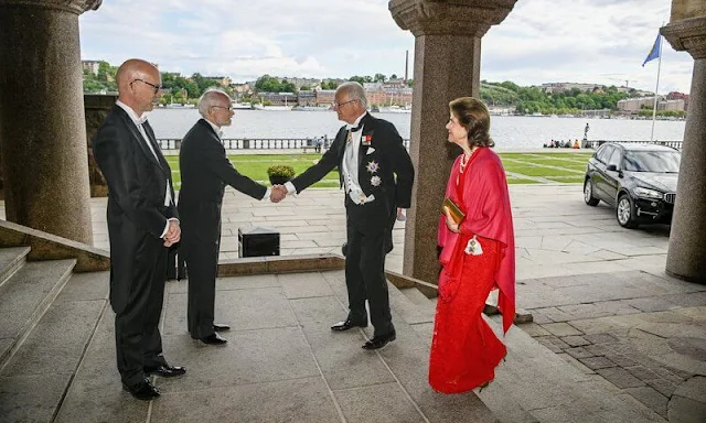 Queen Silvia wore a red lace gown dress. The Sjöberg Prize in Cancer Research. King Carl Gustaf