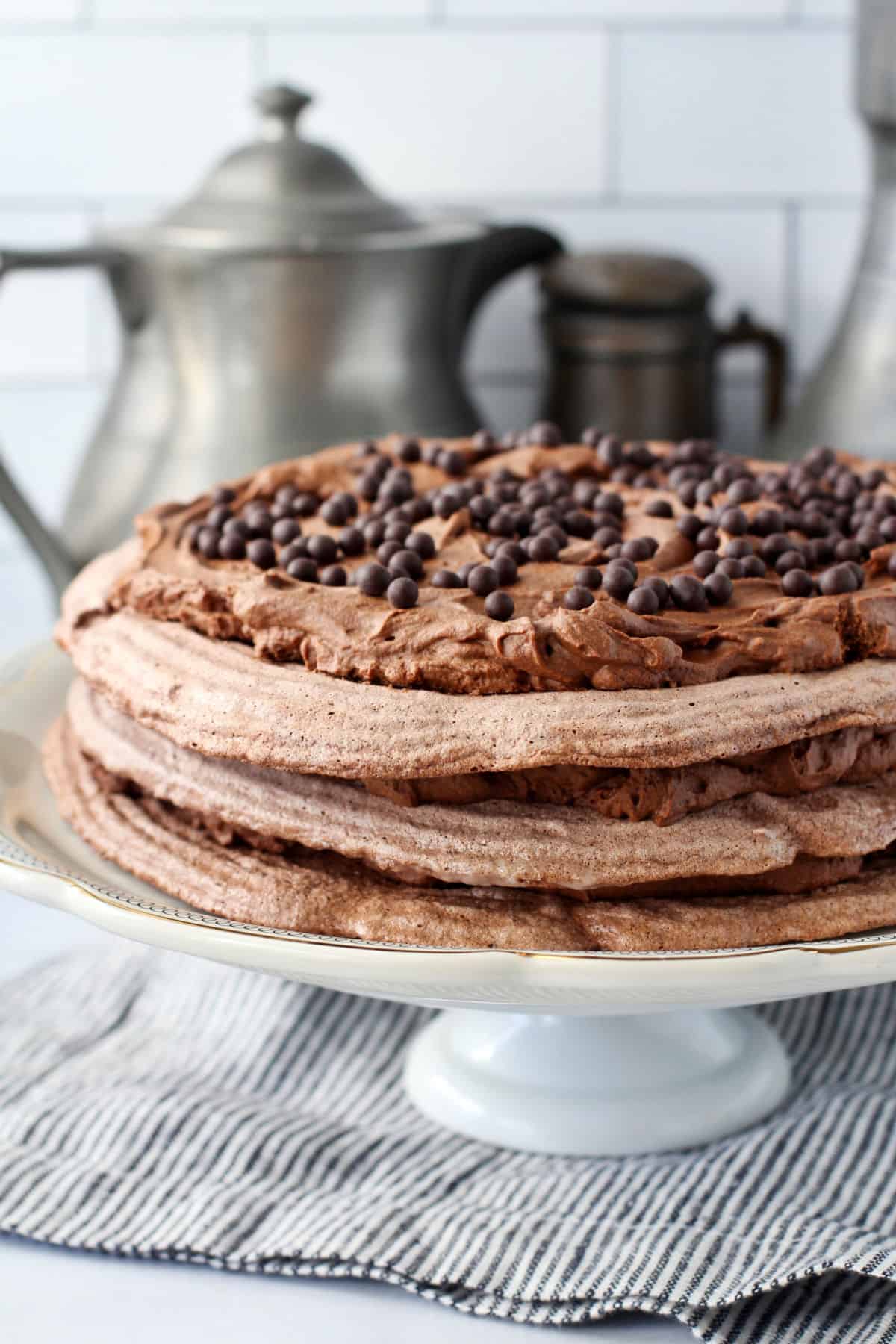 Concorde Chocolate Meringue and Mousse Cake stacked on a cake stand.