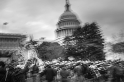 blurru photo  of Capitol building with January 6 rioters