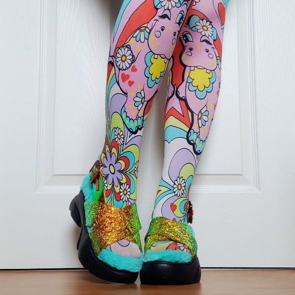 wearing hippo pattern tights with metallic fluffy sandals