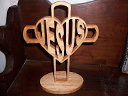 This is a handmade scroll sawn Jesus cross on an oval base.