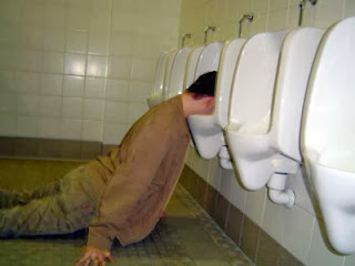 A man passed out in a urinal