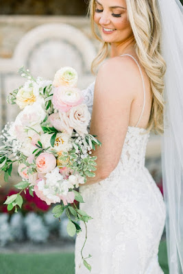 bride in white lace wedding dress with pink and orange bouquet