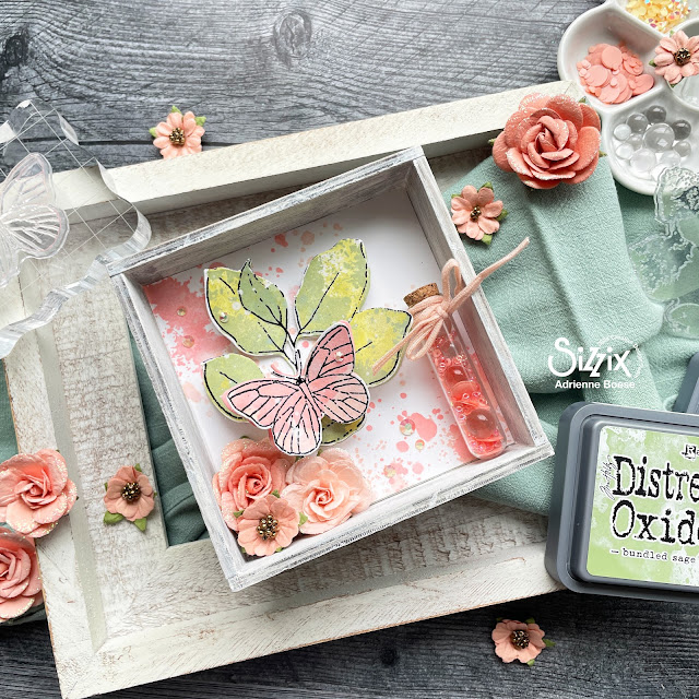 Mixed media vignette in coral and sage created with Sizzix 49 & Market layered stamps, Tim Holtz vignette box, Distress Oxides, and Prima Marketing flowers.
