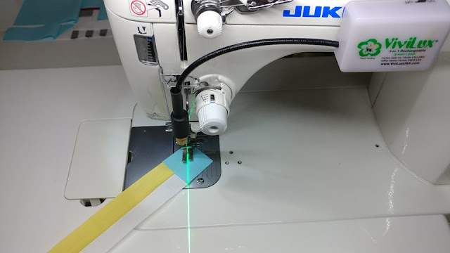 Using a sewing machine laser