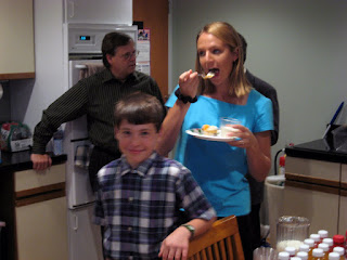 Annick Marshall takes a bite of Zyrek's going-away cake while photophiliac Evan Thompson grins at the camera.