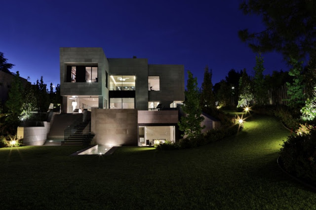 The Memory House by A-Cero Architects at night from the backyard 
