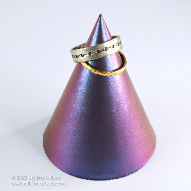 Colour shifting cone-shaped ring holder in shades of orange, pink and blue