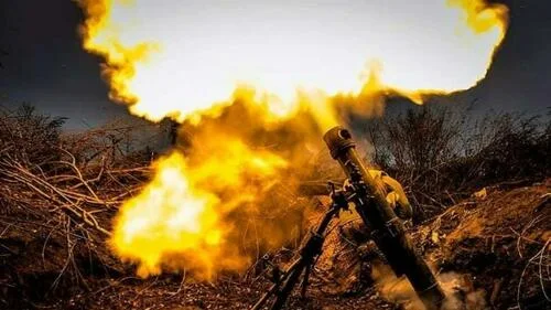 Ukrainian troops fire a mortar at an undisclosed location in Ukraine.