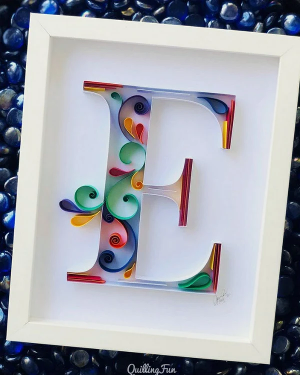 contemporary, colorful quilled letter E in white frame
