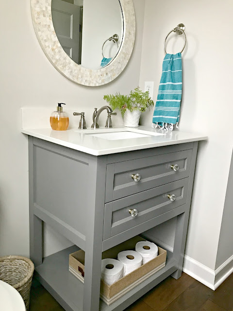 small vanity with drawers and open shelf
