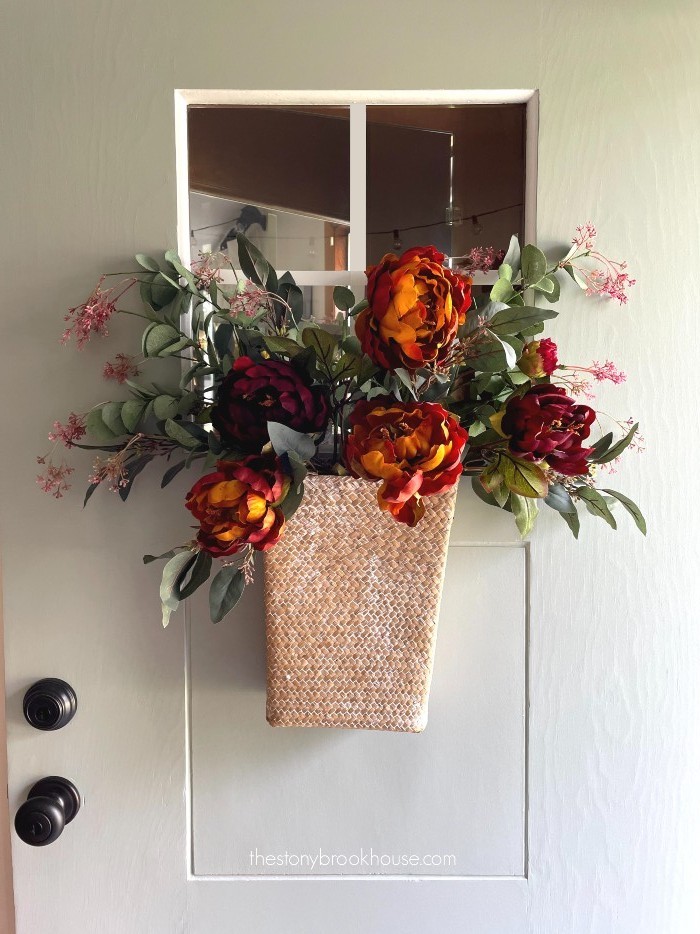 Adding large flowers to front door basket