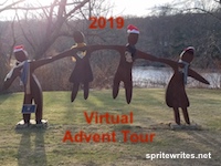 A picture of 4 wooden statues of two adults and two children on a glade by the river dancing while holding hands