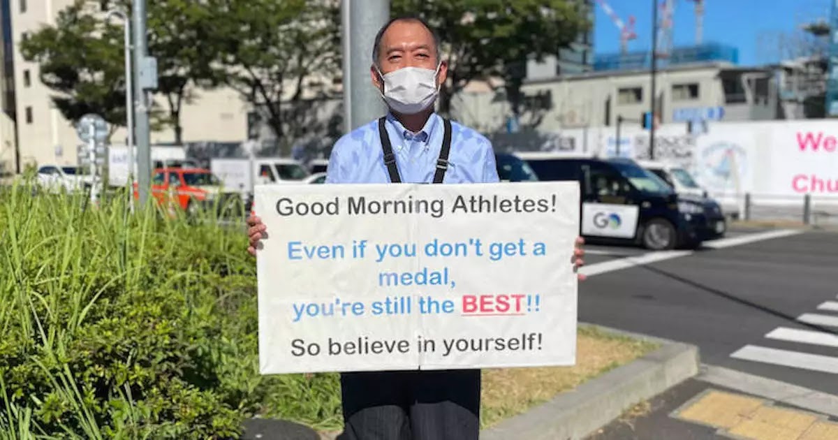 This Man Stood Outside The Tokyo Olympic Village Every Day Holding Motivational Placards For Every Athlete Competing At The Olympics