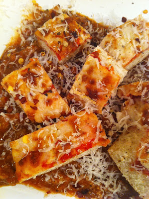 Pizza Bites alla Bolognese as an appetizer snack with parmesan on white plate