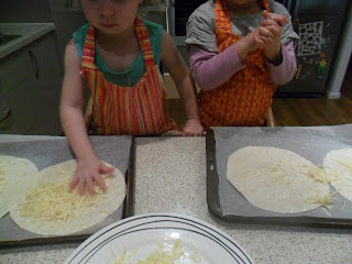 Sprinkling grated cheese onto tortillas for tostadas recipe