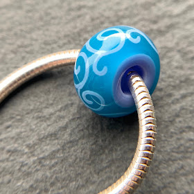 Handmade lampwork glass big hole bead by Laura Sparling made with CiM Peacock Feather