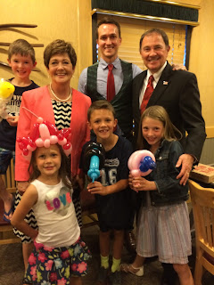 The Governor's family getting balloon animals at the Brick Oven